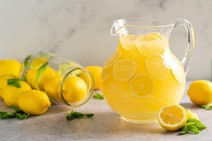 A Pitcher of Nectar Lemonade with Fresh Lemons Limes
