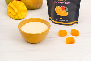 Magical Mango Gummy Mix Bag with Gummies on Marble Countertop